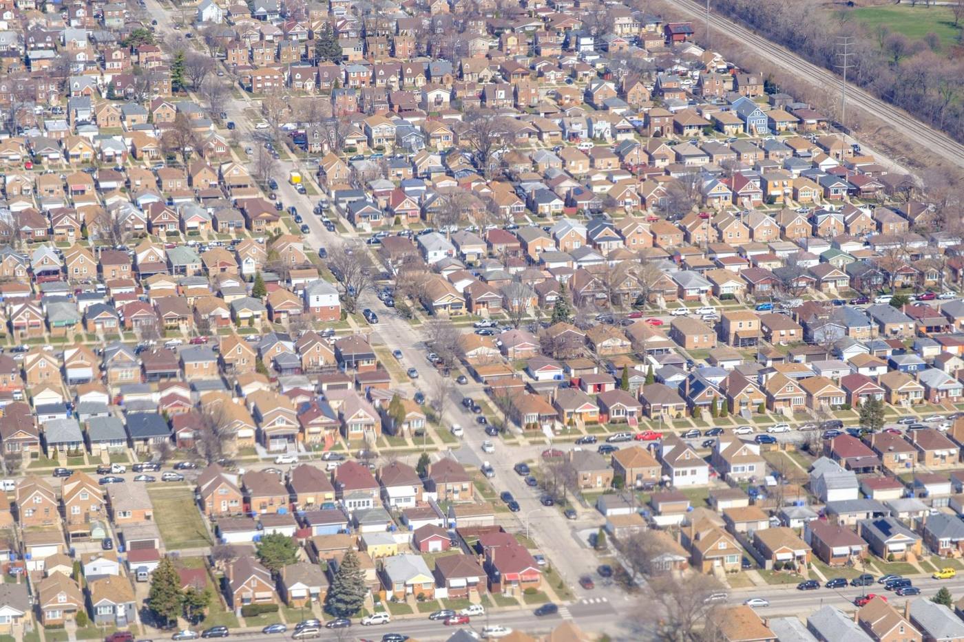 An aerial view of a dense residential neighborhood with many small detached houses