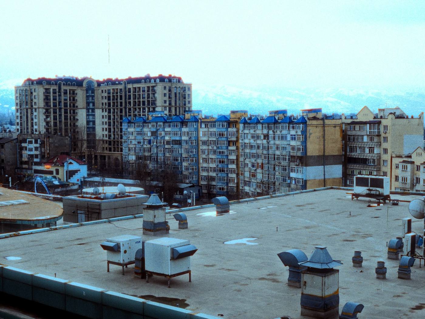 Apartment buildings seen from a rooftop with vents