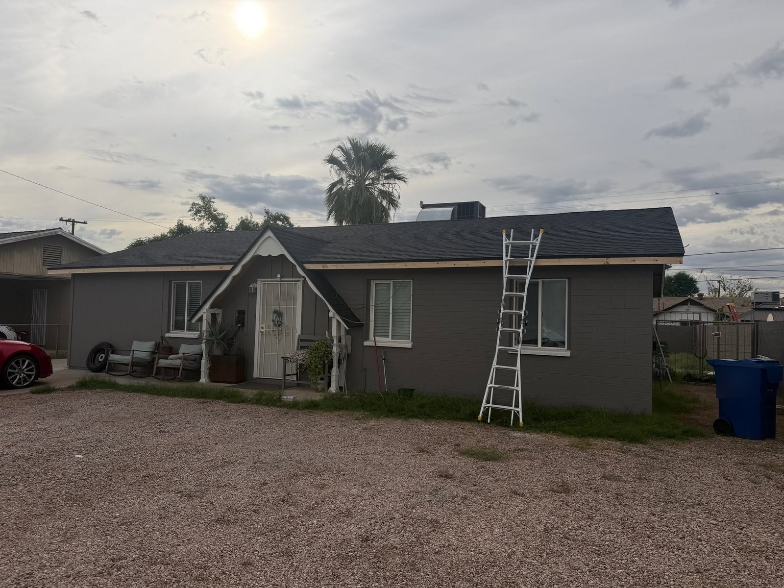 The same house finished in new dark architectural shingles with new fascia