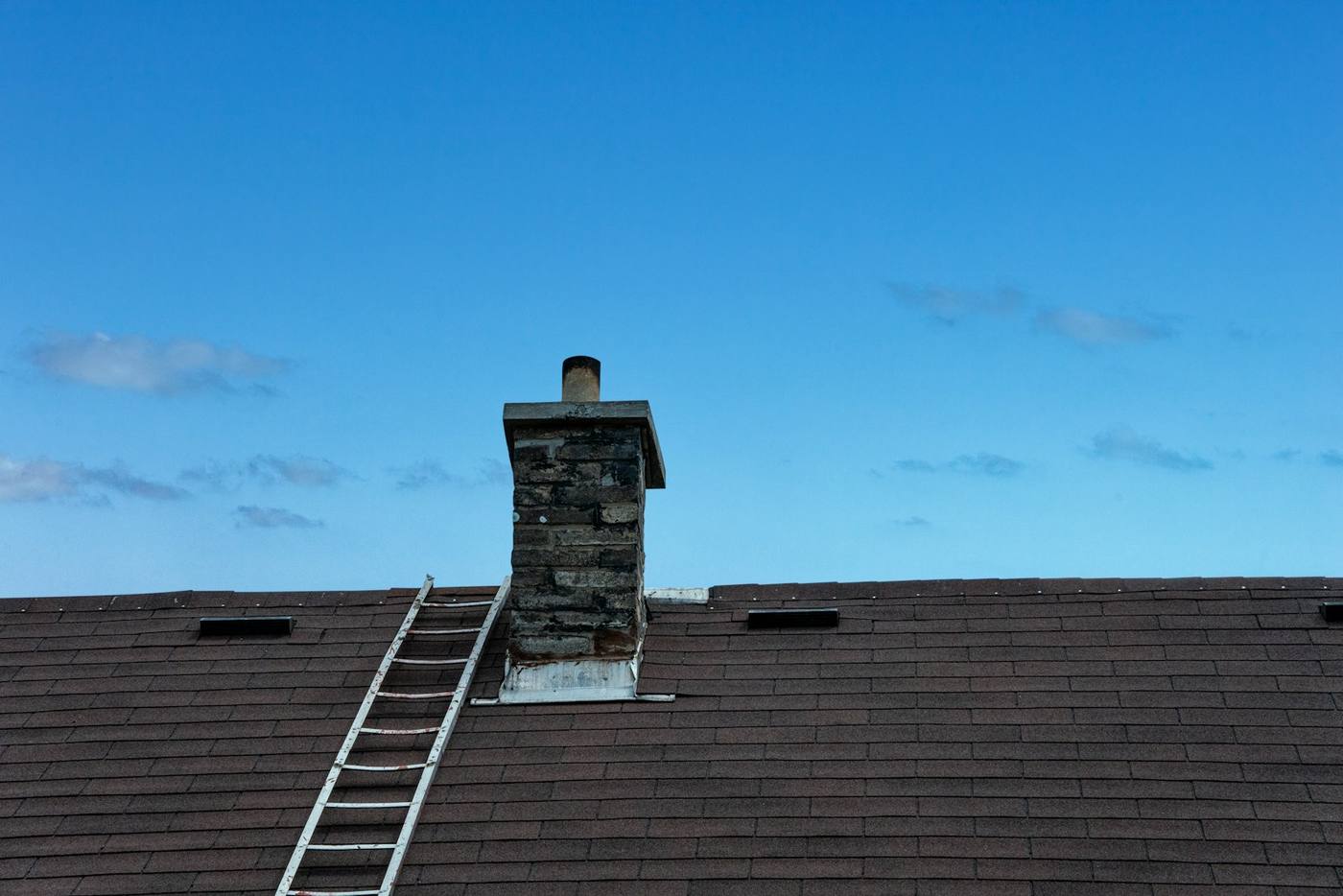 A ladder is on the roof of a house