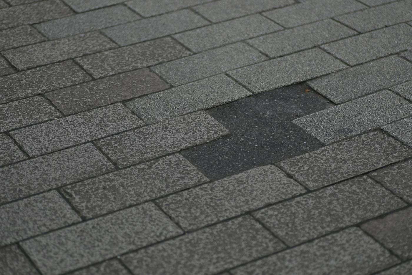 Damaged asphalt shingle roof with missing shingles