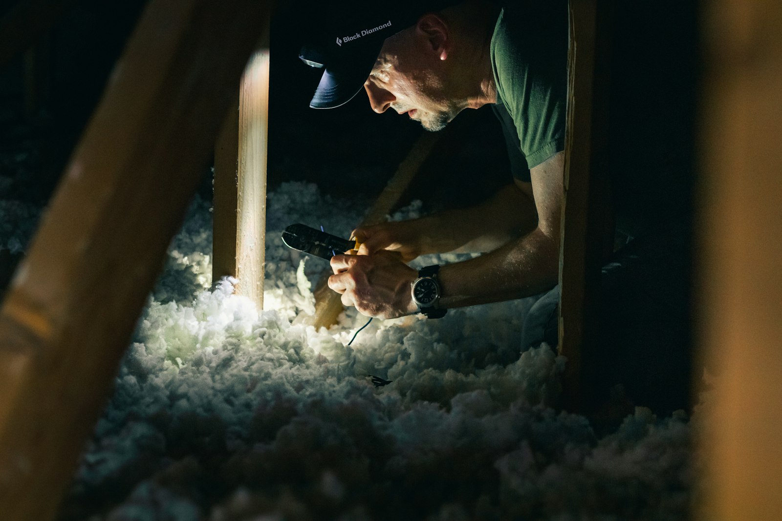 Checking loose-fill insulation in an attic by headlamp